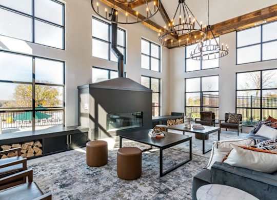 A modern living room with a fireplace and a large window.