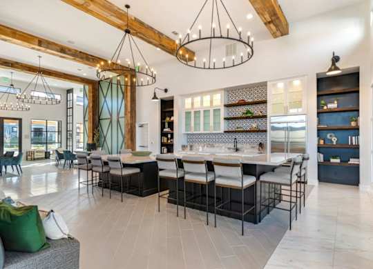 A modern kitchen with a dining area and a living room.