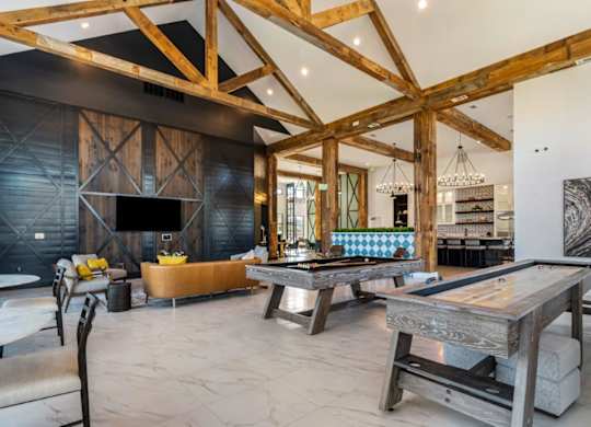 A modern living room with a wooden ceiling and a large coffee table.