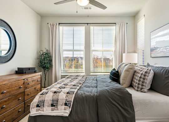 A bedroom with a large bed and a mirror on the wall.