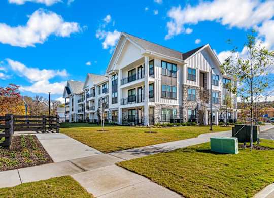 A modern building with a green lawn in front.