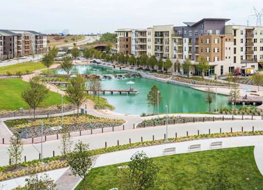A view of a resort with a pool and apartment buildings.
