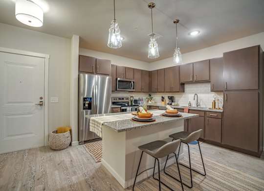 Kitchen with Island at Discovery at The Realm, Texas