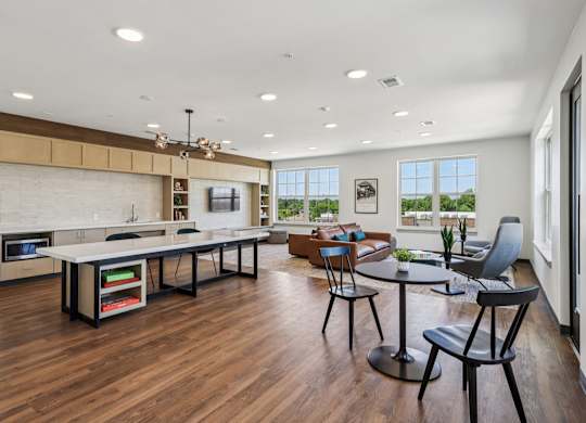 A modern kitchen with a dining table and chairs.