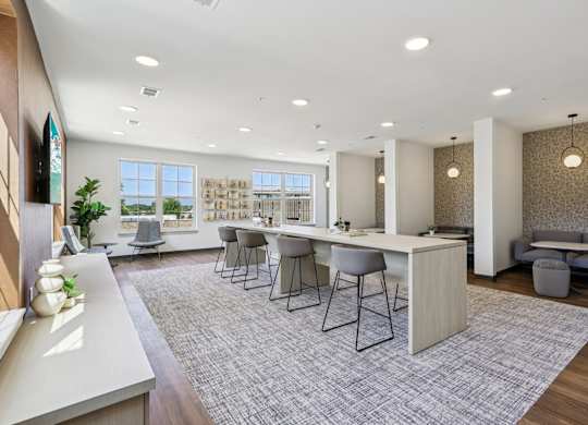 A modern kitchen with a dining area and a view of the ocean.