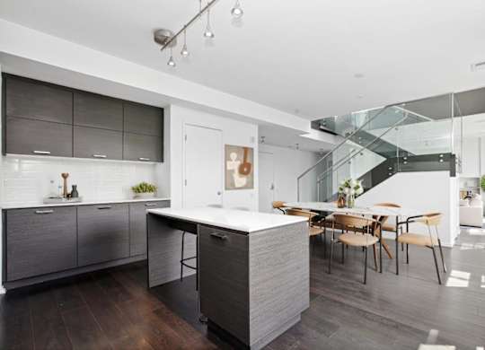 a kitchen with a large island and a dining table