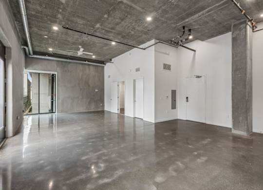A large, empty room with concrete floors and walls.