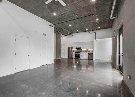 A large empty room with a concrete floor and ceiling.