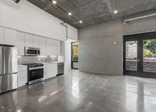 A modern kitchen with stainless steel appliances and a large island.