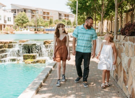 a family walking by the water fountain at the resort