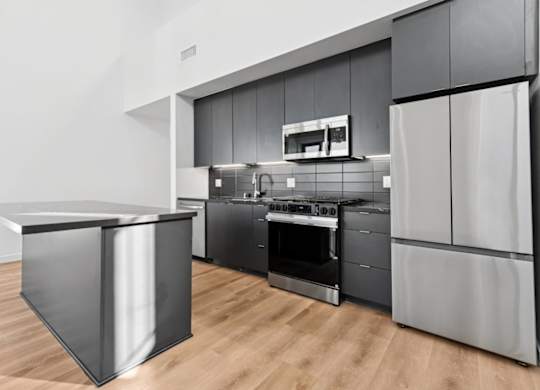 A modern kitchen with a black and white color scheme.