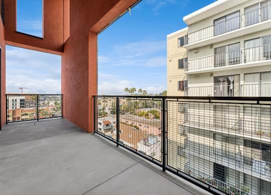 A balcony with a view of a cityscape.