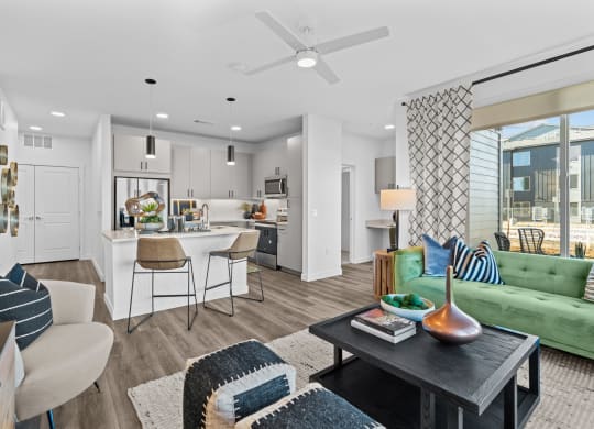 an open living room with a kitchen and a dining room