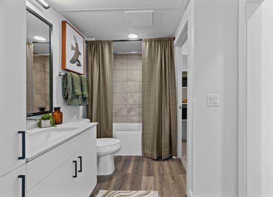 a bathroom with a shower and a toilet and a shower curtain