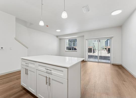 A kitchen with white cabinets and a countertop.
