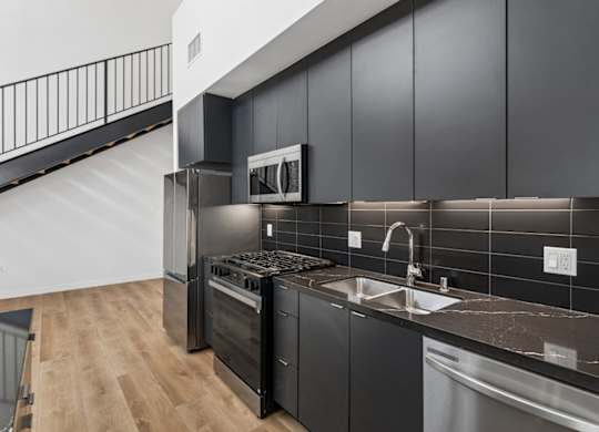 A modern kitchen with a stainless steel dishwasher and oven.