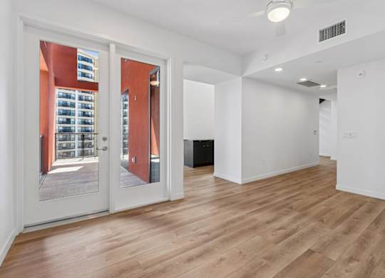A room with a wooden floor and white walls.