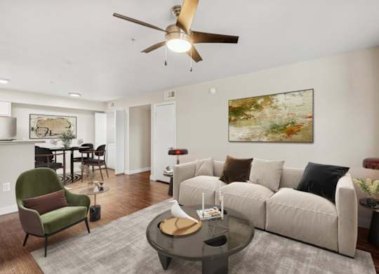 A living room with a green chair and a white couch.