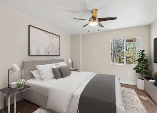 A bedroom with a large bed and a ceiling fan.