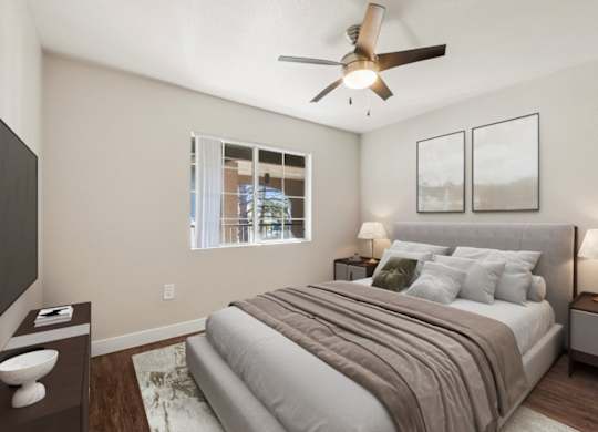 A bedroom with a bed, nightstands, and a ceiling fan.