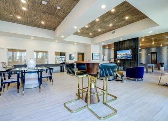The Dylan resident clubhouse with tables and chairs and a flat screen tv