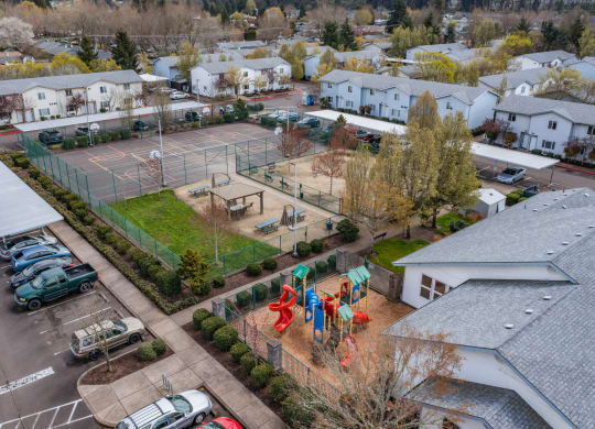 an aerial view of a backyard with a basketball court and tennis court