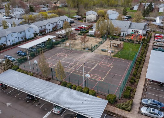 an aerial view of a basketball court in a parking lot