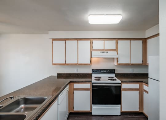 a kitchen with white cabinets and a black stove top oven