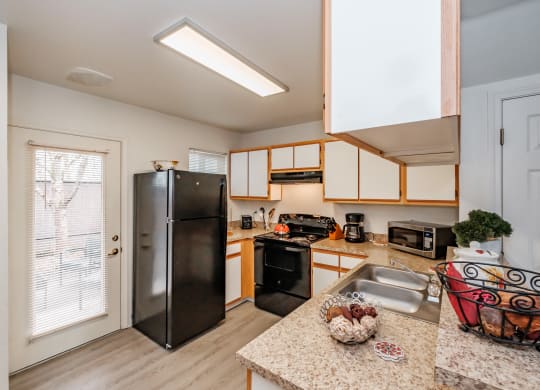 the kitchen has granite countertops and stainless steel appliances