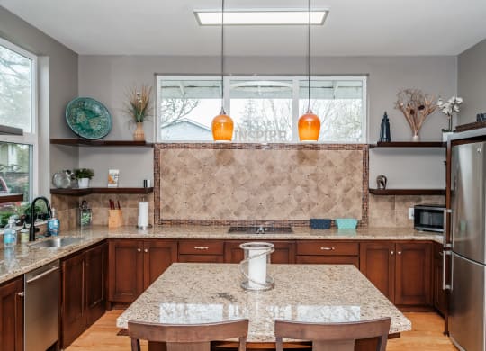a kitchen with brown cabinets and a granite counter top