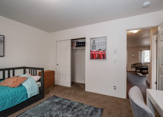 a bedroom with a bed and a desk