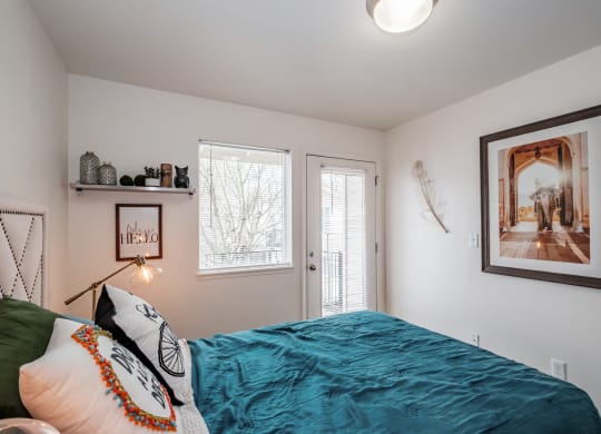 a bedroom with a bed and two windows