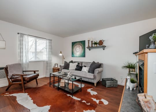 a living room with white walls and hardwood floors