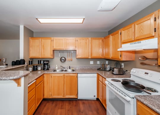 a kitchen with wooden cabinets and granite countertops