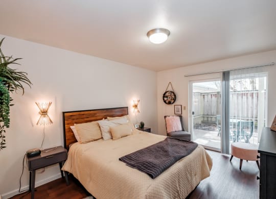 a bedroom with a bed and a sliding glass door