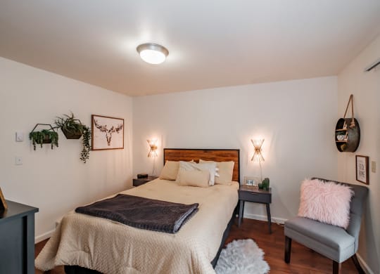 a bedroom with a bed and a chair