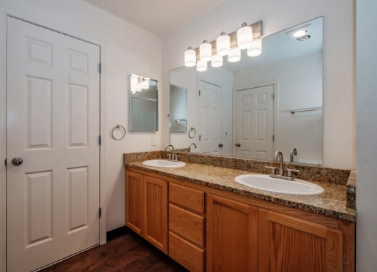 a bathroom with two sinks and a white door