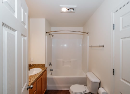 a bathroom with a toilet sink and bathtub