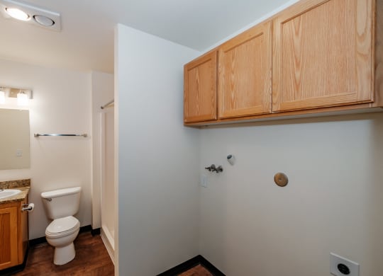a bathroom with a toilet sink and mirror