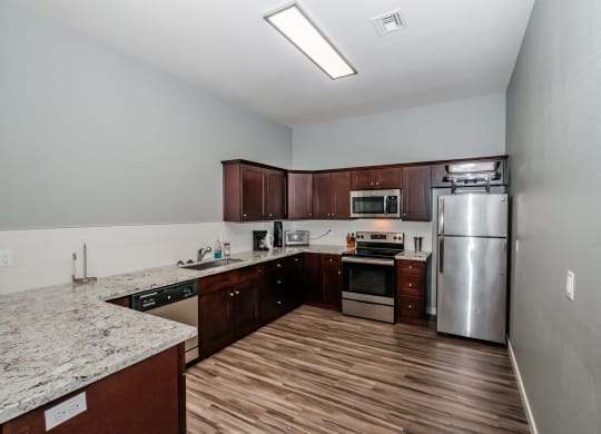 a kitchen with wood floors and stainless steel appliances
