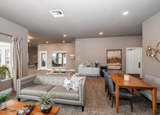a living and dining room area with a couch table and chairs