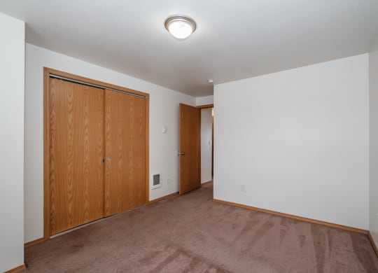 a bedroom with a carpeted floor and white walls