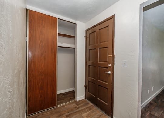 a bedroom with a closet and a door that is open