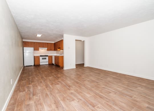 a bedroom with a medium hardwood floor and white walls