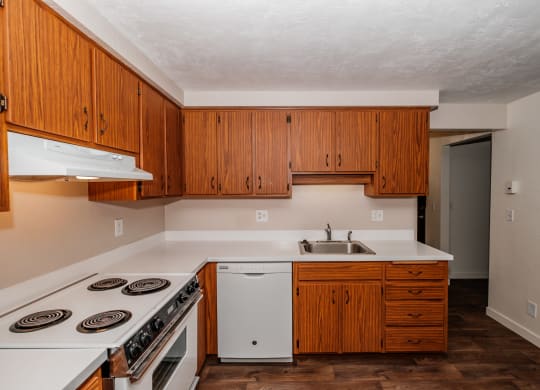 a kitchen with white appliances and wooden cabinets