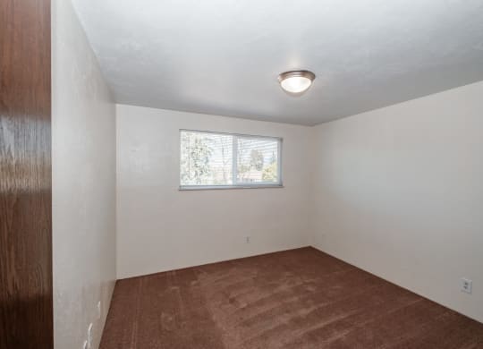 a small room with white walls and a small window