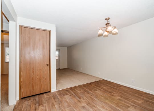 a living room with hardwood floors and a wooden door