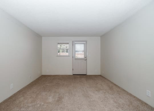 a bedroom with a carpeted floor and white walls