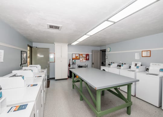 a room with a table and washing machines