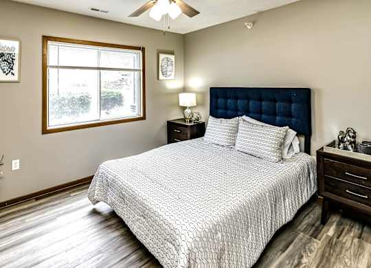 A bedroom with a large bed and a window.